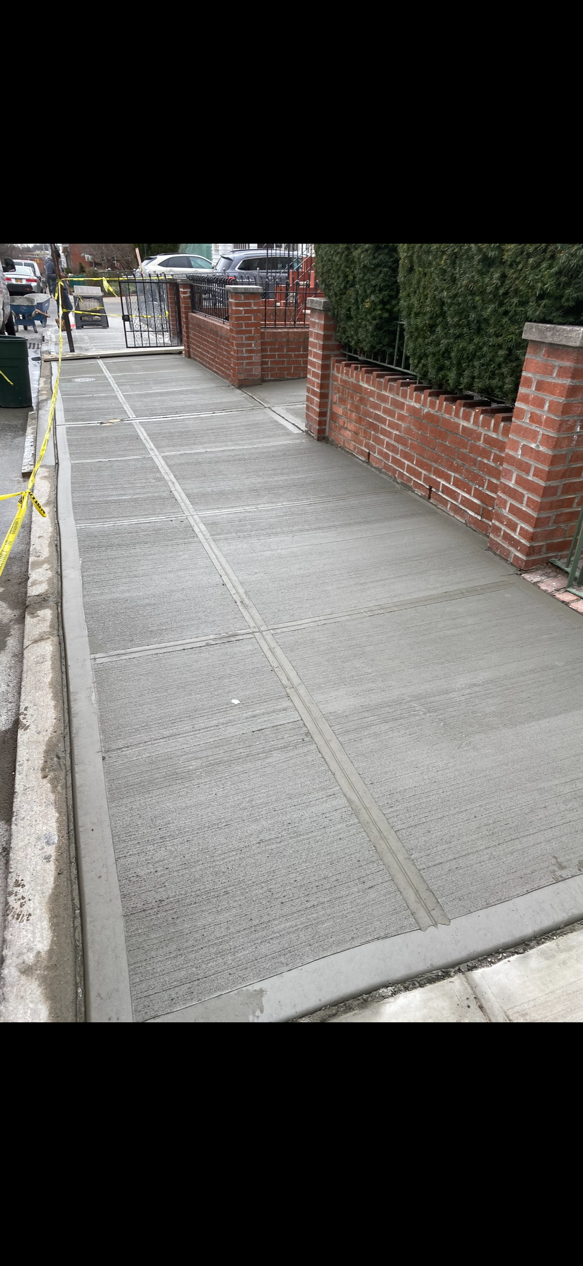 Concrete driveway with brick pillar accents