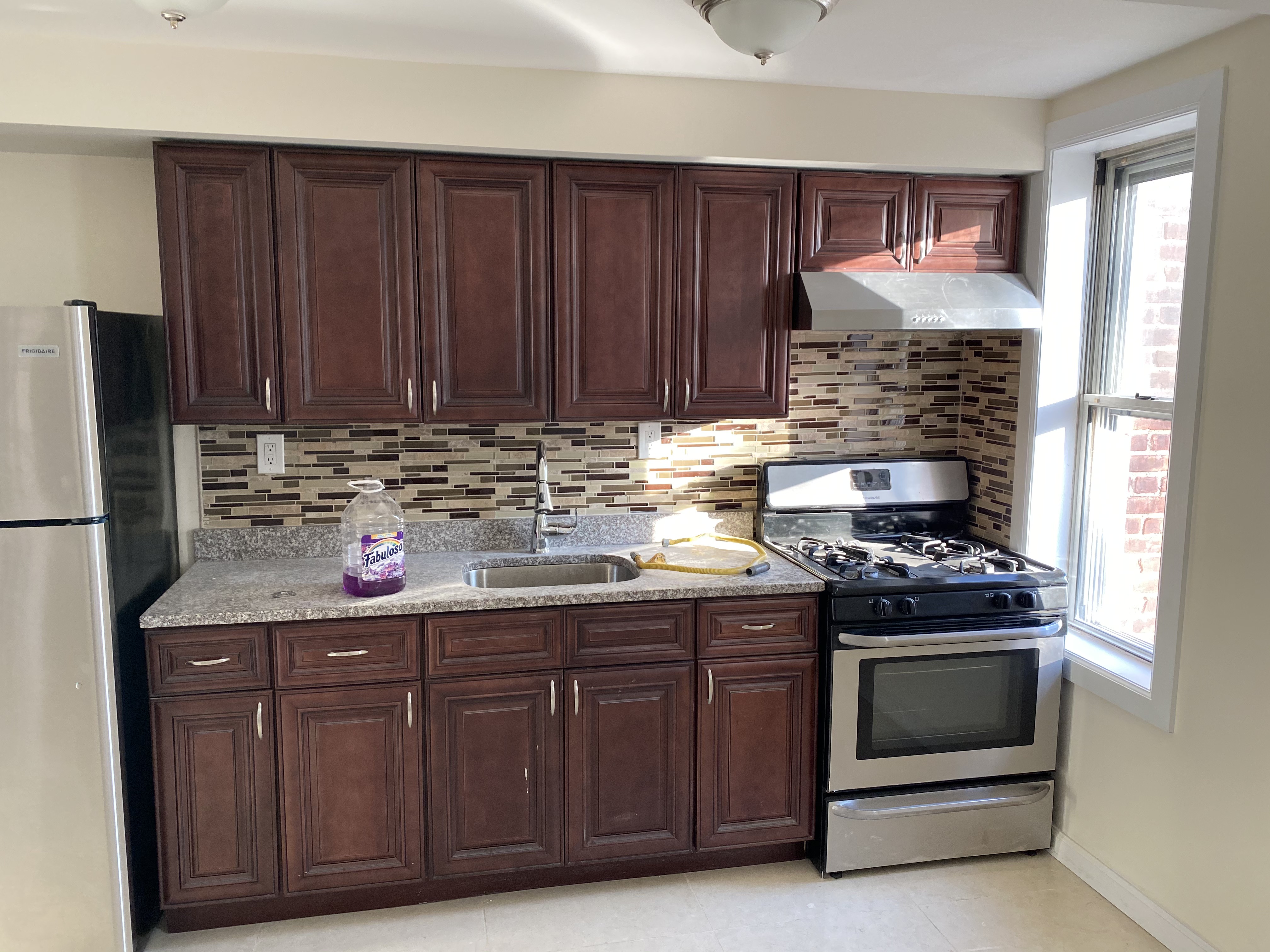 Kitchen with cherry wood cabinets and granite