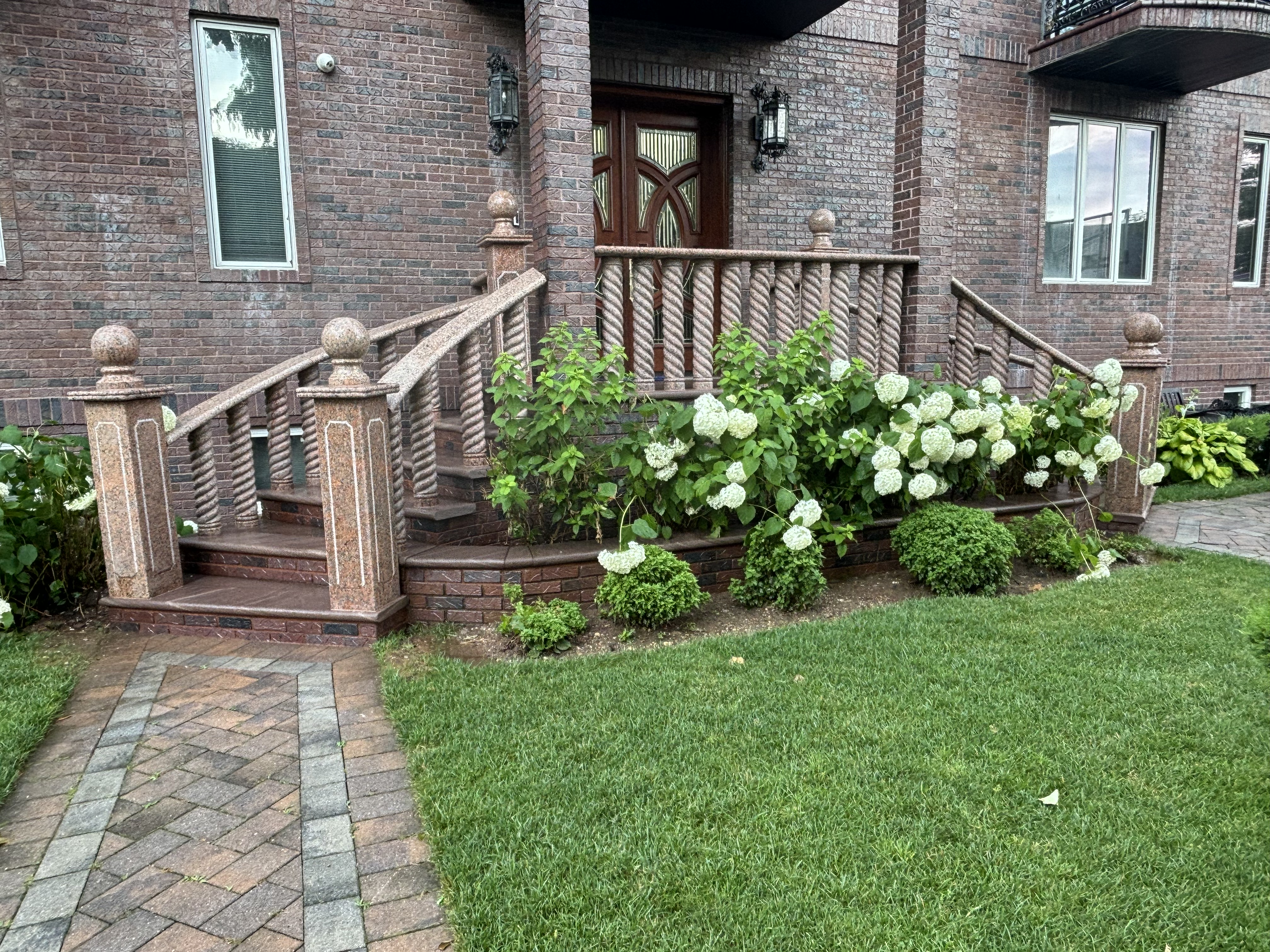 Curved granite staircase with landscaping